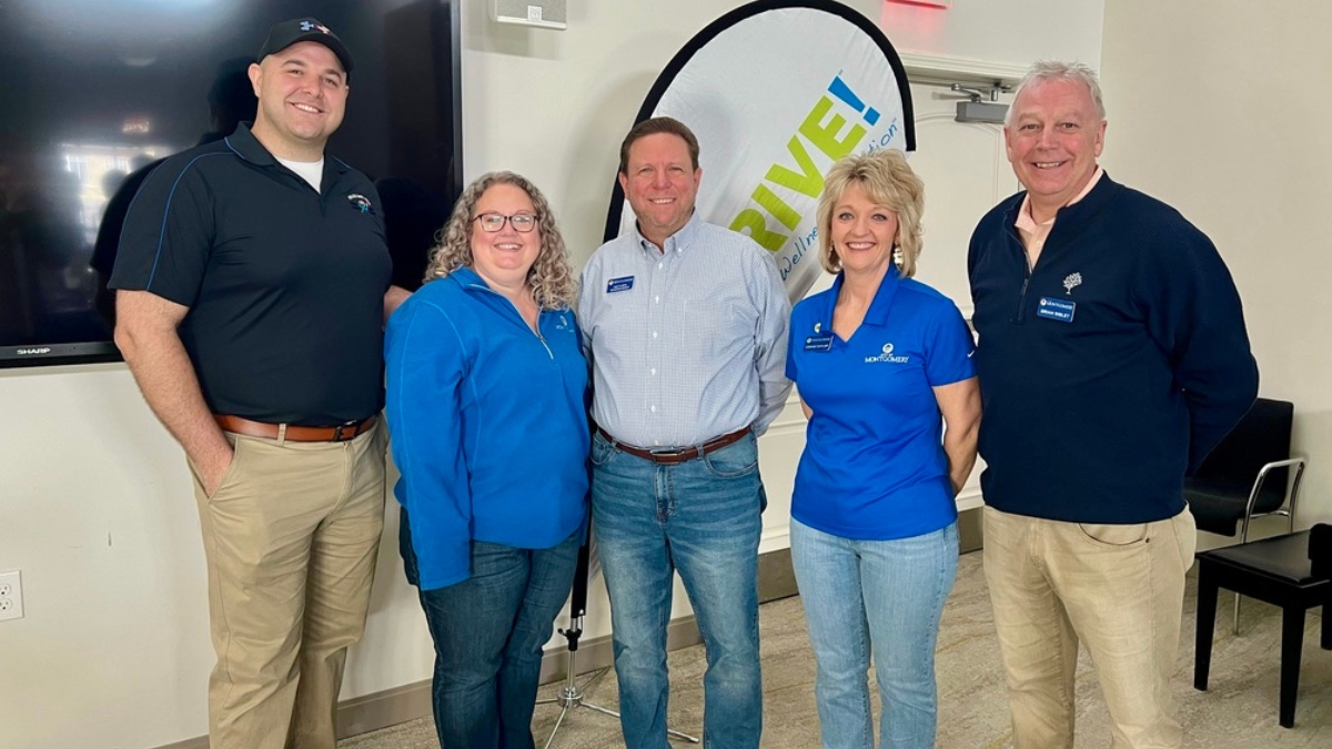 Five adults standing in front of WeTHRIVE! banner.