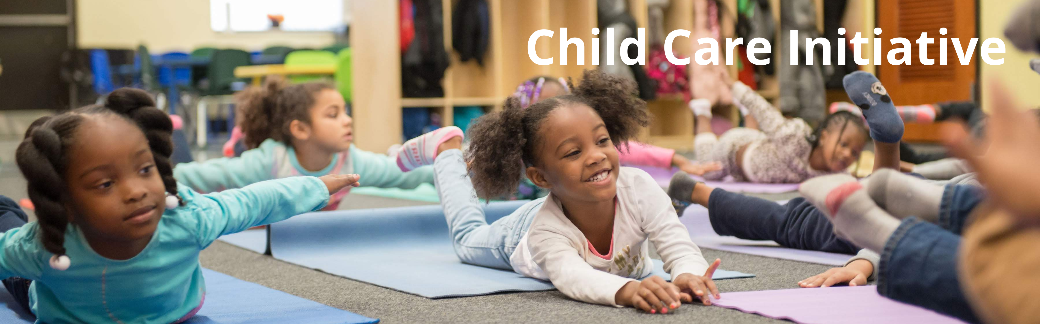 Preschool age children doing yoga on yoga mats.