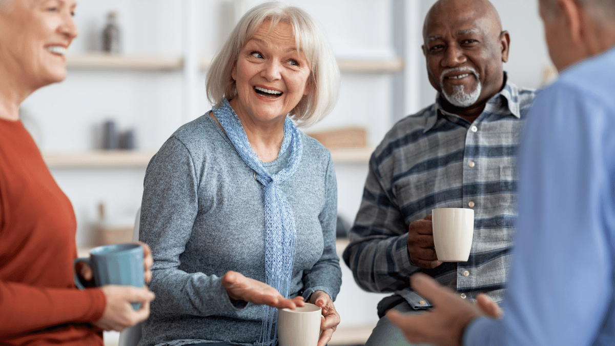 Group of older adults talking over coffee.